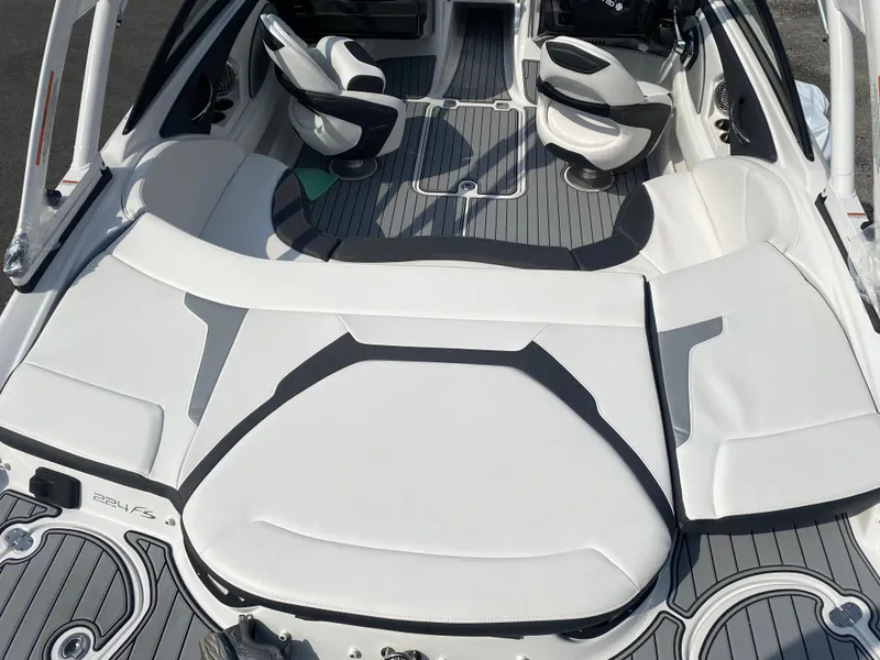 Slide: The Image of 2025 Monterey 224FS boat interior with white and gray seating and sleek design. - 10