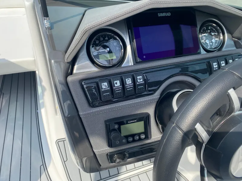 Slide: The Image of 2025 Monterey 224FS boat dashboard with gauges, controls, and steering wheel. - 12