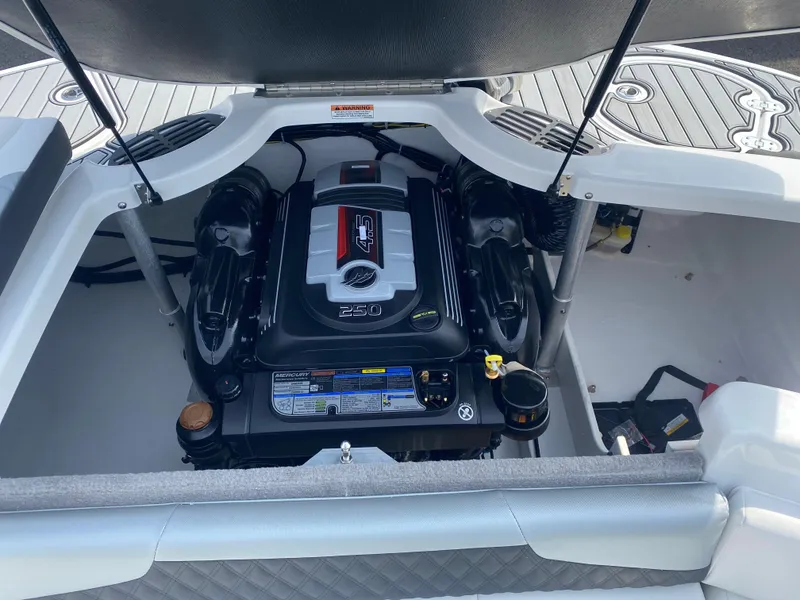 Slide: The Image of 2025 Monterey 224FS boat engine compartment with open hatch, showcasing powerful engine design. - 21