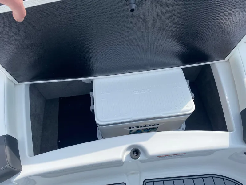 Slide: The Image of 2025 Monterey 224FS boat storage compartment with cooler inside. - 22