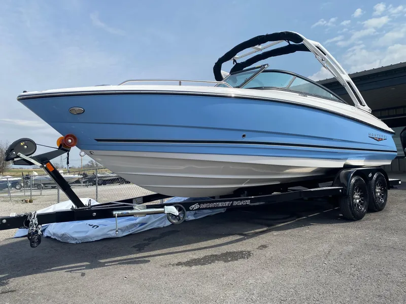 Slide: The Image of 2025 Monterey 224FS boat on trailer, blue and white design, parked outdoors. - 3