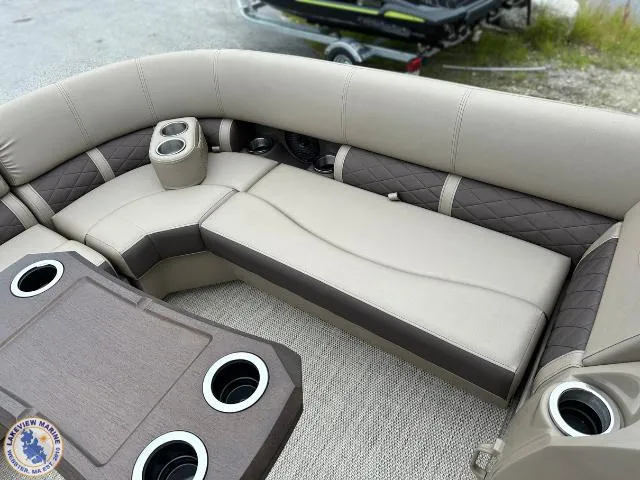 Slide: The Image of 2024 Bennington 23 LSRC boat interior with beige seating and cup holders. - 2