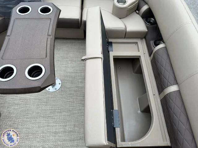 Slide: The Image of 2024 Bennington 23 LSRC boat interior with storage compartment and cupholders. - 3