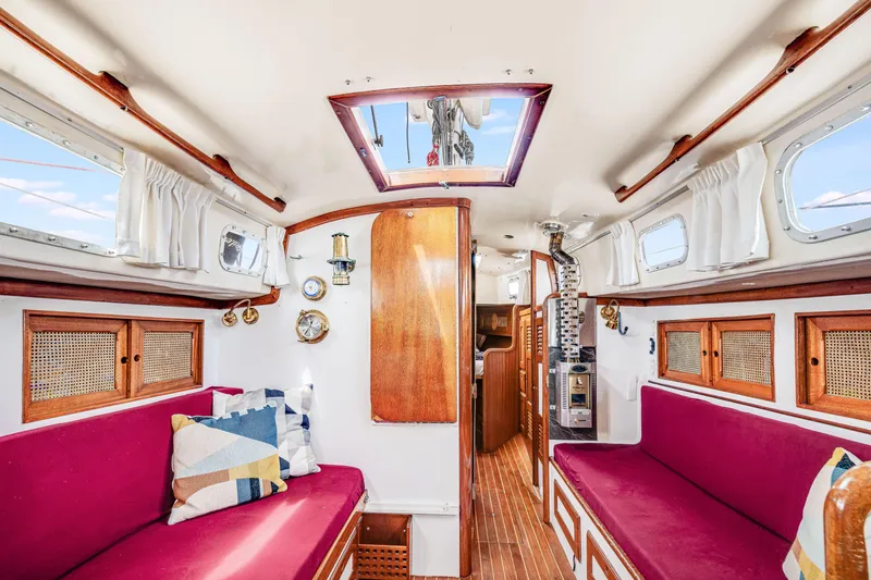 Slide: The Image of Interior of 1981 Bristol 40 sailboat with red seating and wooden accents. - 18