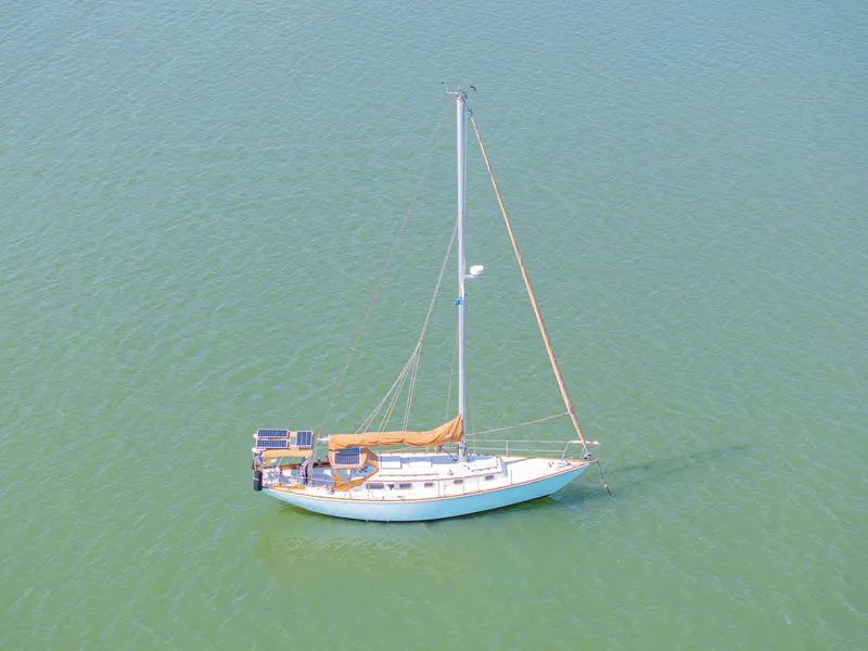Slide: The Image of 1981 Bristol 40 sailboat with solar panels on calm water. - 2