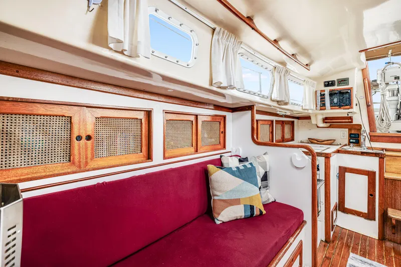 Slide: The Image of Interior of 1981 Bristol 40 sailboat with red seating and wooden accents. - 30