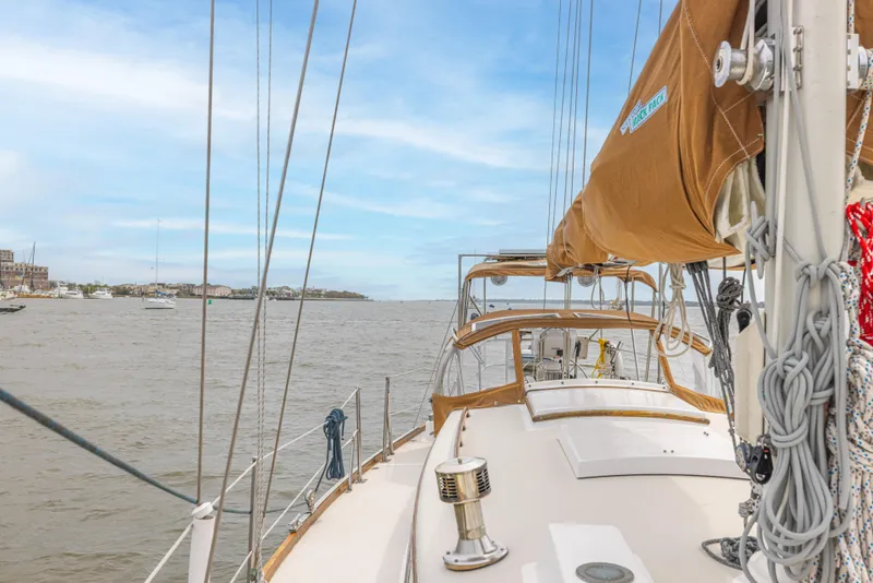 Slide: The Image of Sailing on a 1981 Bristol 40 yacht with tan sails and clear skies. - 41