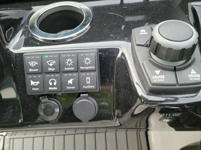 Slide: The Image of Control panel of a 2018 Yamaha Boats 242 Limited S, featuring various switches and dials. - 10