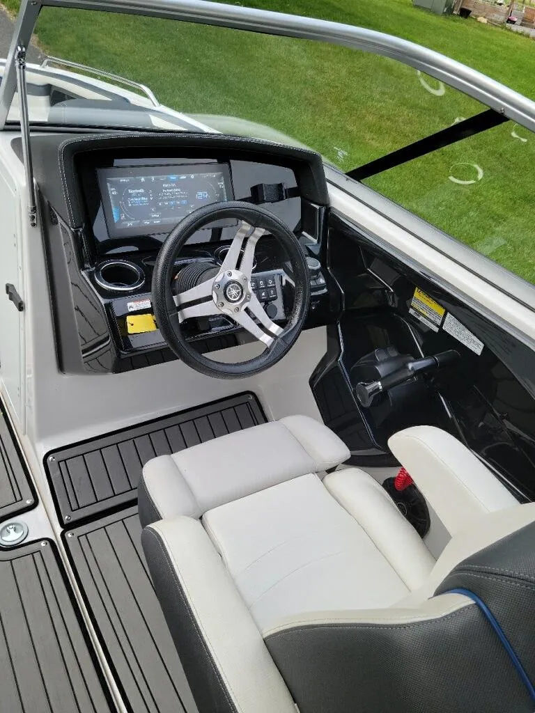 Slide: The Image of 2018 Yamaha Boats 242 Limited S cockpit with steering wheel and dashboard controls. - 13