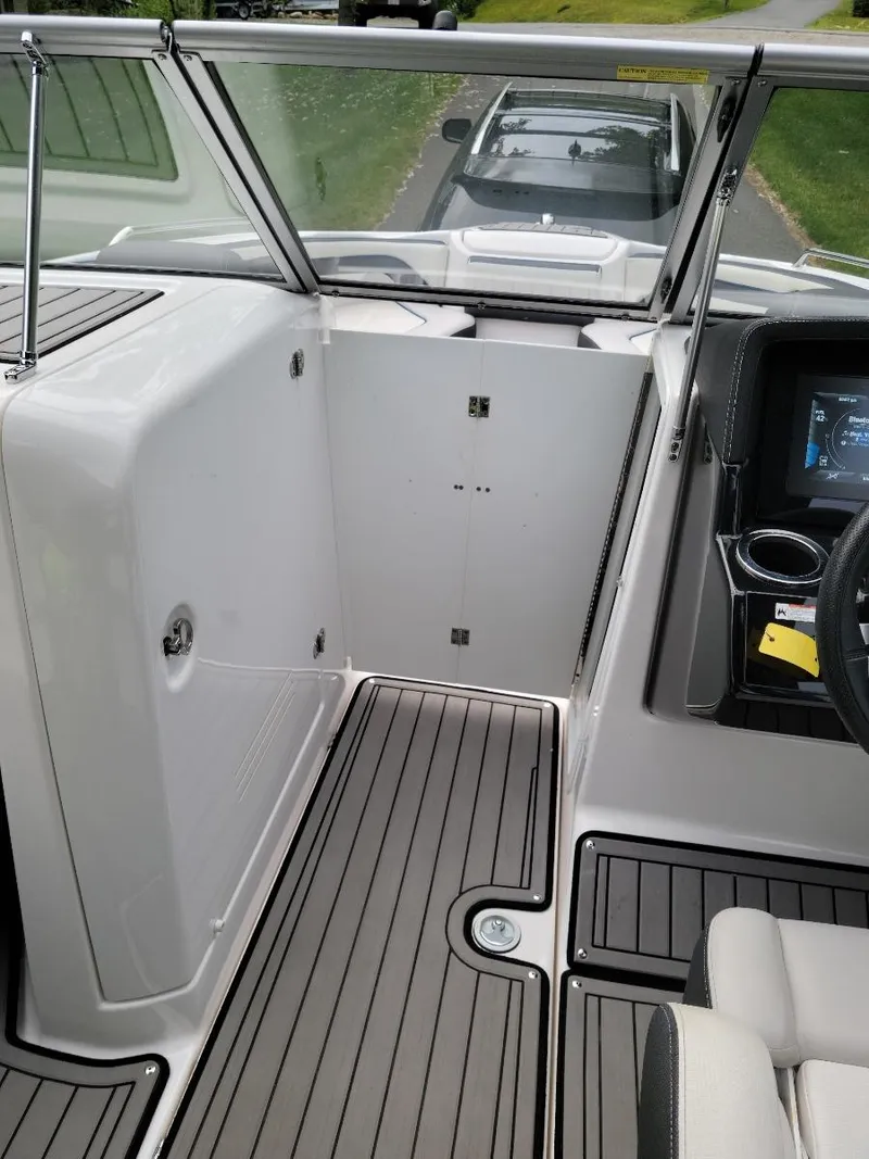 Slide: The Image of 2018 Yamaha Boats 242 Limited S interior with sleek design and modern dashboard. - 16