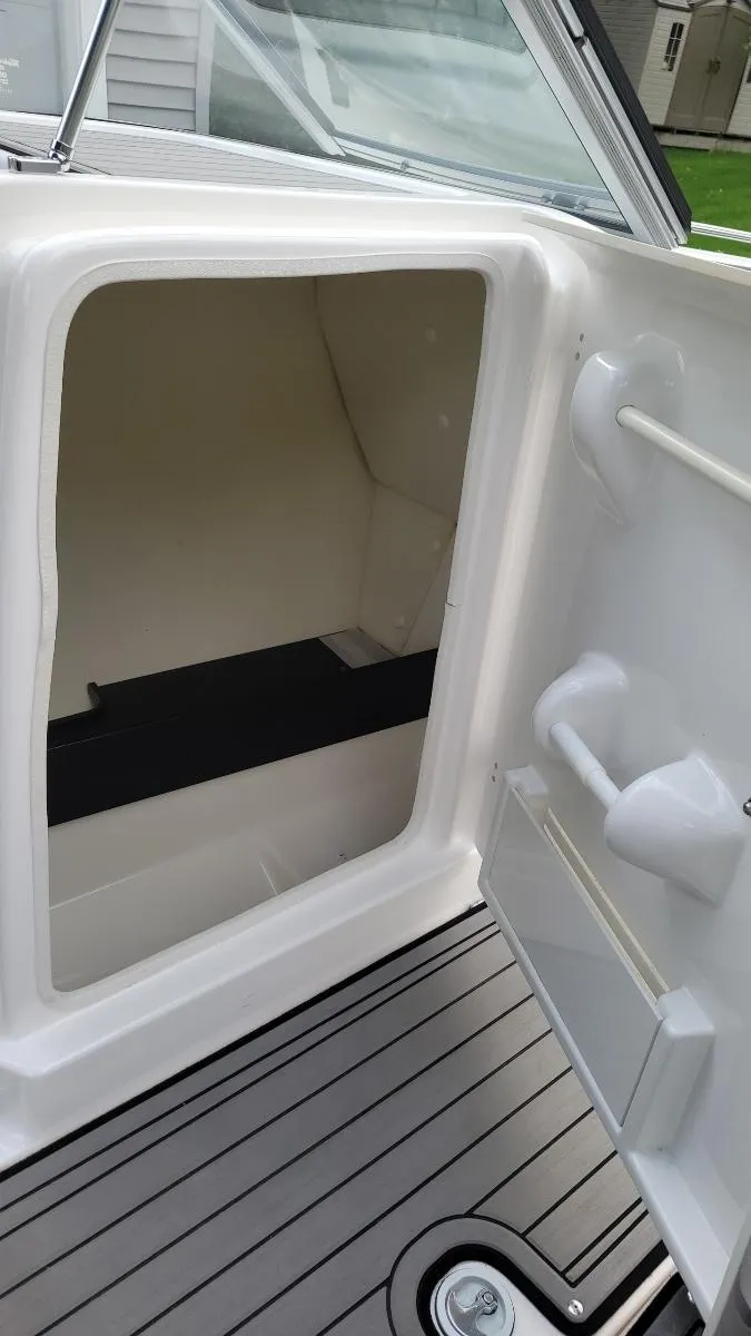 Slide: The Image of 2018 Yamaha Boats 242 Limited S interior storage compartment with sleek design and modern features. - 18