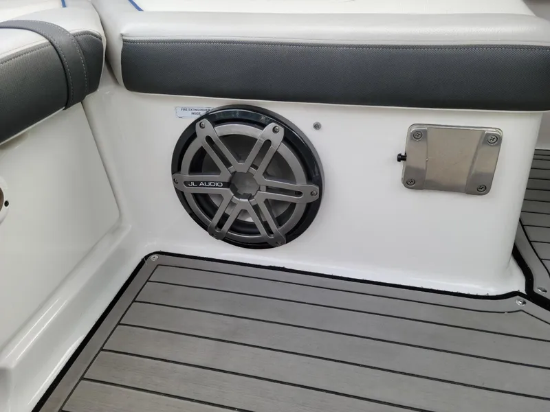 Slide: The Image of 2018 Yamaha Boats 242 Limited S interior with JL Audio speaker and cushioned seating. - 6