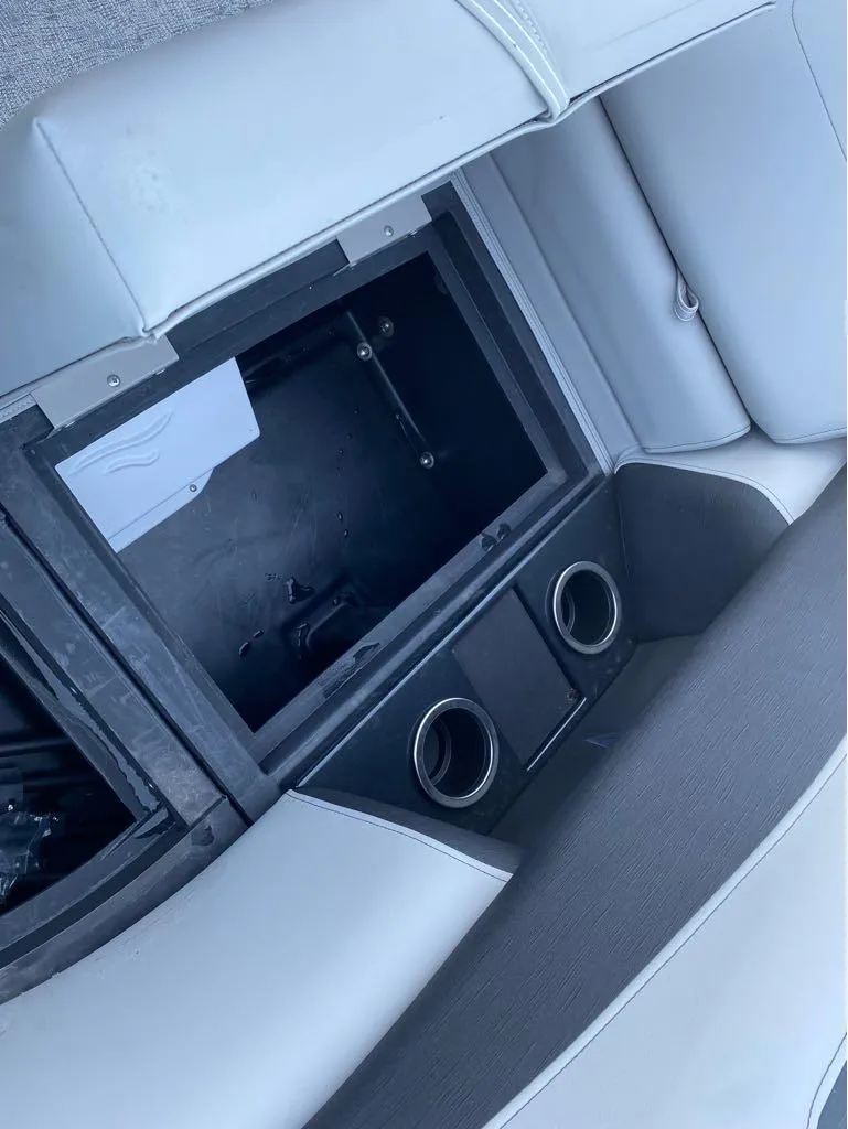 Slide: The Image of 2024 Berkshire LE Series 22RFX LE boat interior storage compartment with cup holders. - 13