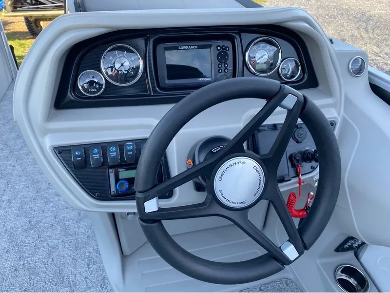Slide: The Image of 2024 Berkshire LE Series 22RFX LE boat dashboard with steering wheel and gauges. - 2