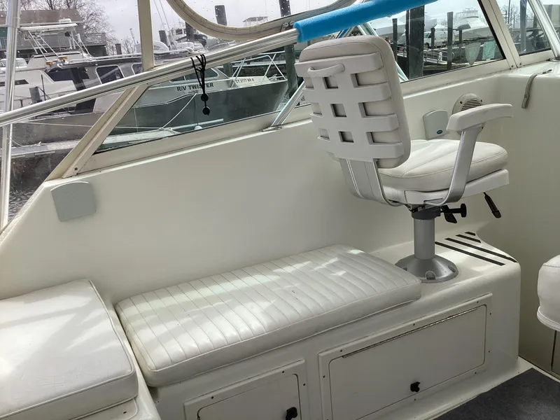 Slide: The Image of 2001 Henriques 28 Express boat interior with white seating and helm chair. - 11