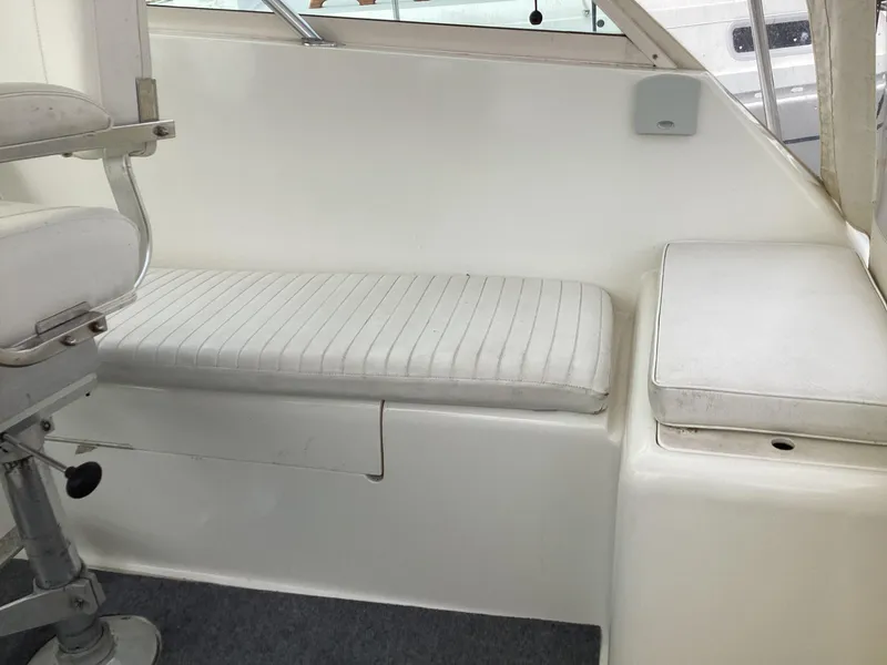 Slide: The Image of 2001 Henriques 28 Express boat interior with white seating and clean design. - 13