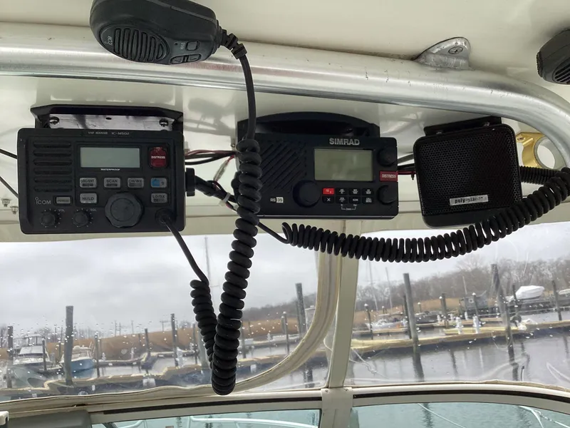 Slide: The Image of 2001 Henriques 28 Express boat with marine radios and speakers, docked at a marina. - 16