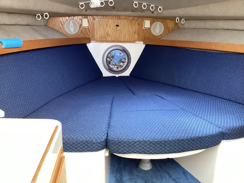 Slide: The Image of 2001 Henriques 28 Express cabin interior with blue upholstery and wooden accents. - 19
