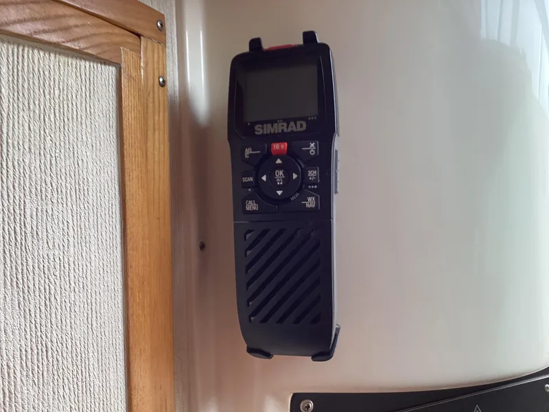 Slide: The Image of Simrad marine radio mounted on a 2001 Henriques 28 Express boat interior. - 26