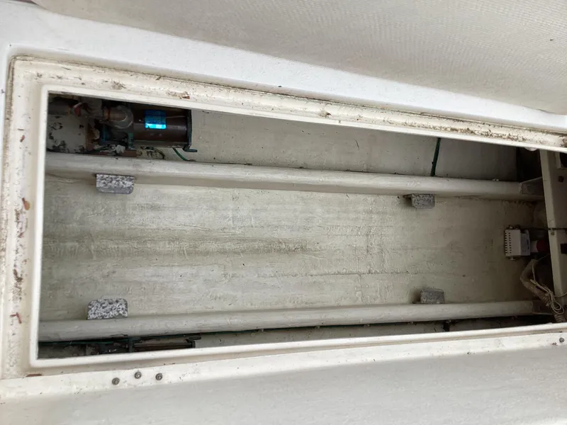 Slide: The Image of 2001 Henriques 28 Express boat storage compartment, empty and clean interior. - 28