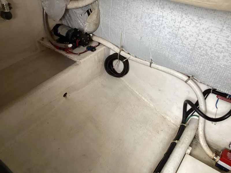 Slide: The Image of 2001 Henriques 28 Express boat interior with visible wiring and equipment. - 29