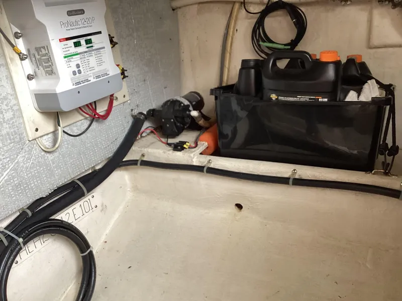 Slide: The Image of 2001 Henriques 28 Express engine compartment with wiring, oil containers, and equipment. - 30