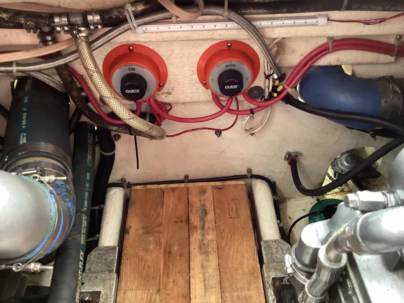 Slide: The Image of Engine compartment of a 2001 Henriques 28 Express boat, featuring wiring and components. - 31