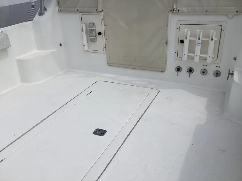 Slide: The Image of 2001 Henriques 28 Express boat deck with storage compartments and rod holders. - 6