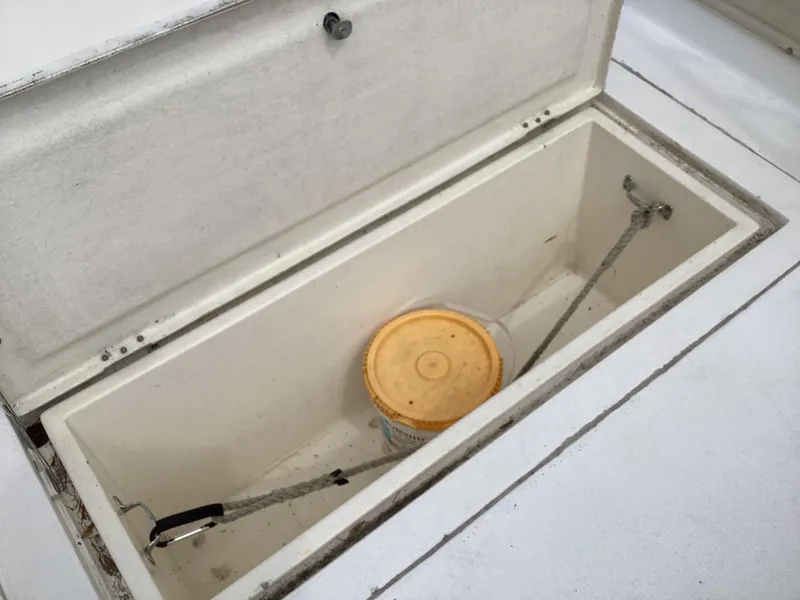 Slide: The Image of Open storage compartment on 2001 Henriques 28 Express boat with a bucket inside. - 7