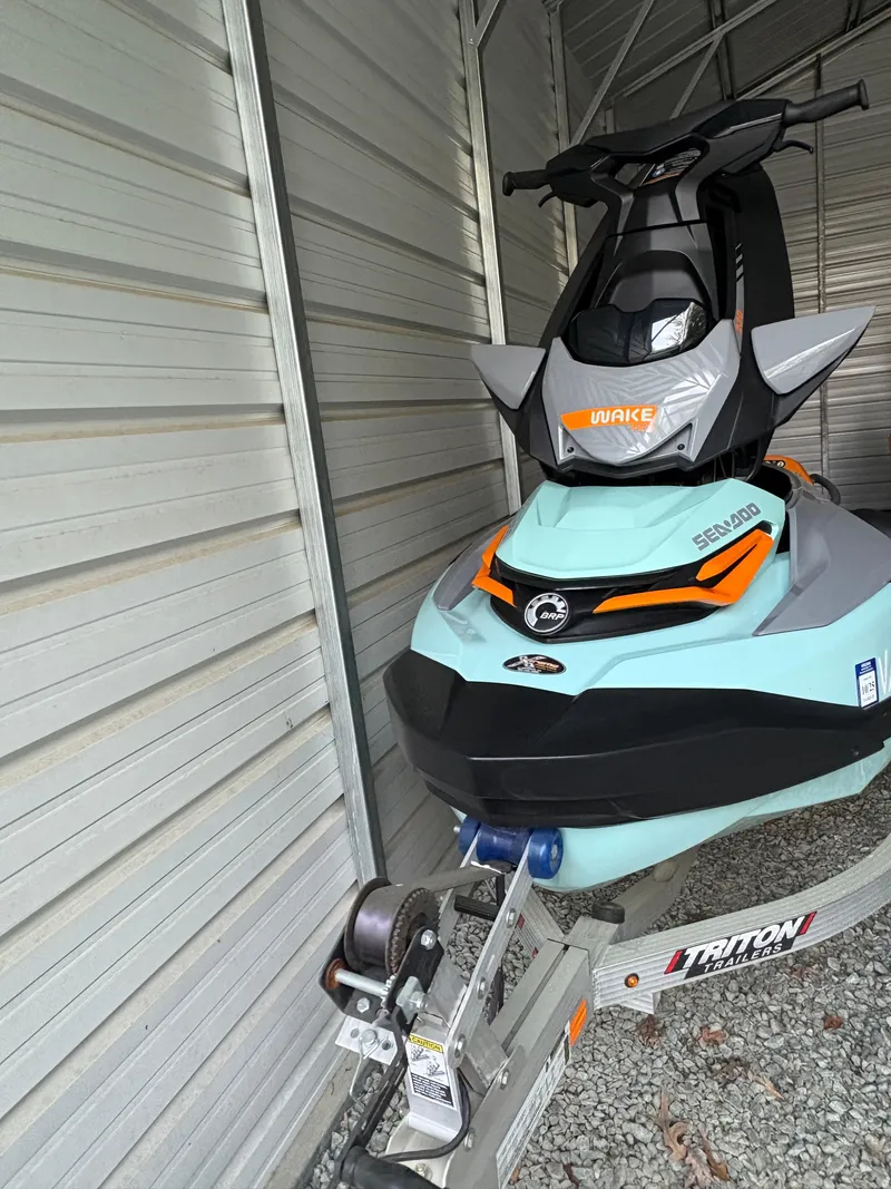 Slide: The Image of 2022 Sea-Doo Wake Pro 230 jet ski on Triton trailer in storage shed. - 10
