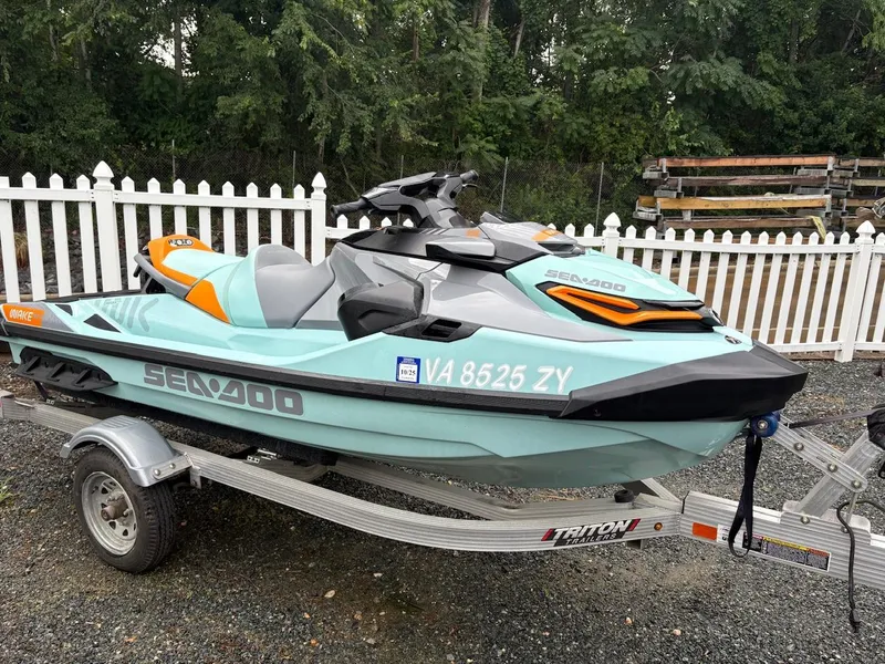 Slide: The Image of 2022 Sea-Doo Wake Pro 230 on trailer, parked near white fence. - 5