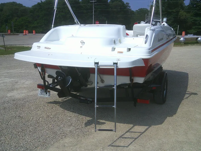 Slide: The Image of 2011 Hurricane SunDeck Sport 188 IO boat, rear view with ladder, parked on gravel. - 14