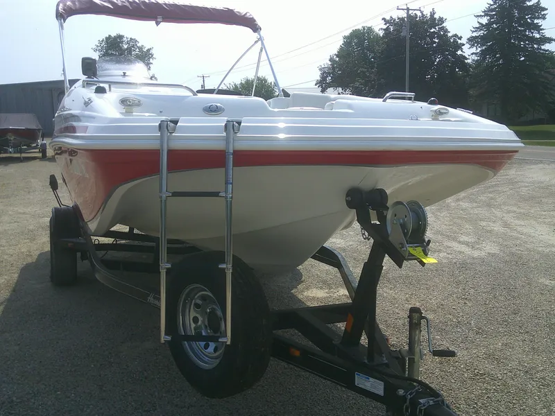 Slide: The Image of 2011 Hurricane SunDeck Sport 188 IO boat on trailer, red and white design. - 15