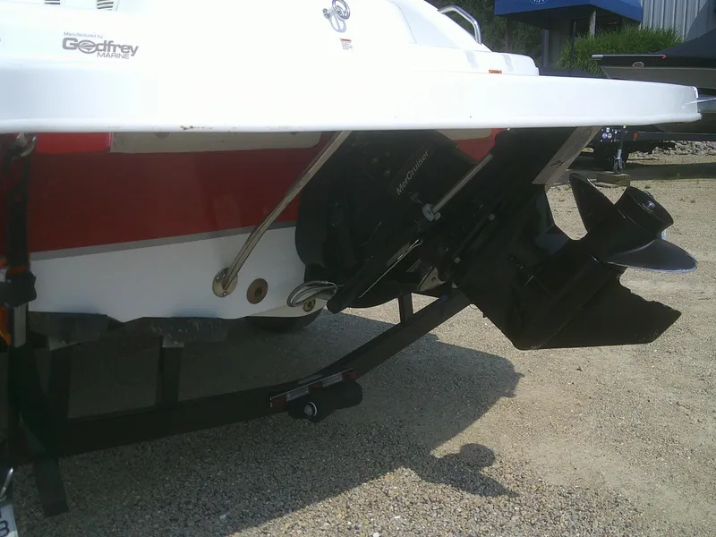 Slide: The Image of 2011 Hurricane SunDeck Sport 188 IO boat stern with outboard motor on trailer. - 18