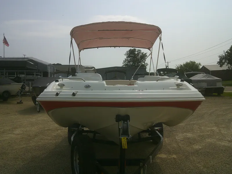 Slide: The Image of 2011 Hurricane SunDeck Sport 188 IO boat with canopy on trailer, parked outdoors. - 3