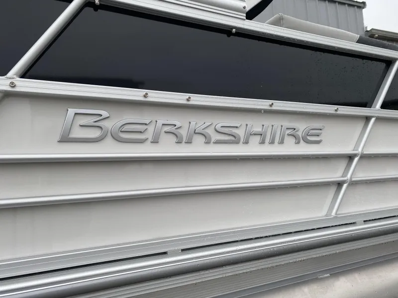 Slide: The Image of 2024 Berkshire 24RFX LE boat, close-up of logo on sleek silver exterior. - 17