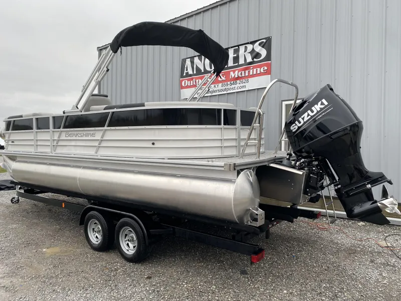 Slide: The Image of 2024 Berkshire 24RFX LE pontoon boat with Suzuki outboard motor on trailer. - 19