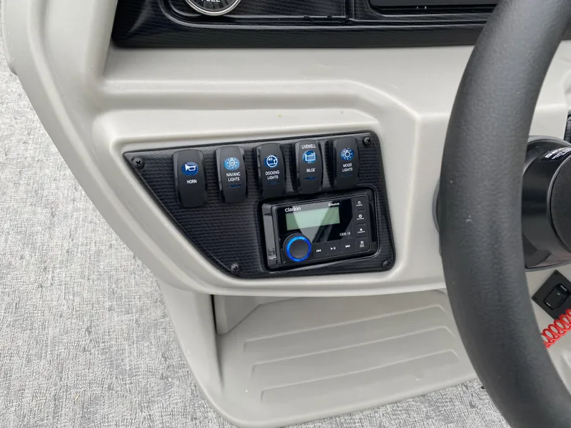 Slide: The Image of Control panel of 2024 Berkshire 24RFX LE boat with switches and audio system. - 3
