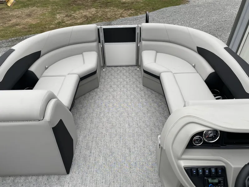 Slide: The Image of 2024 Berkshire 24RFX LE pontoon boat interior with gray seating and modern dashboard. - 4