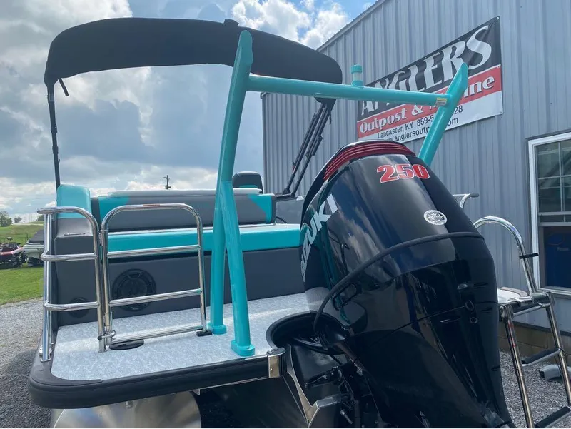Slide: The Image of 2025 Berkshire 25 SB2 STS pontoon boat with Suzuki 250 engine, parked outdoors. - 10