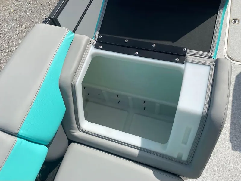 Slide: The Image of 2025 Berkshire 25 SB2 STS boat seat storage compartment, open with teal and gray upholstery. - 11