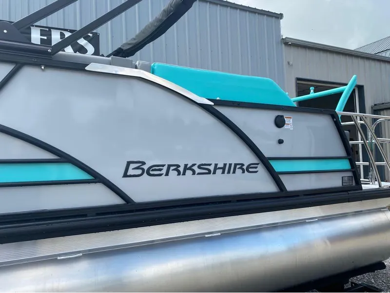 Slide: The Image of 2025 Berkshire 25 SB2 STS pontoon boat with sleek design and turquoise accents. - 15