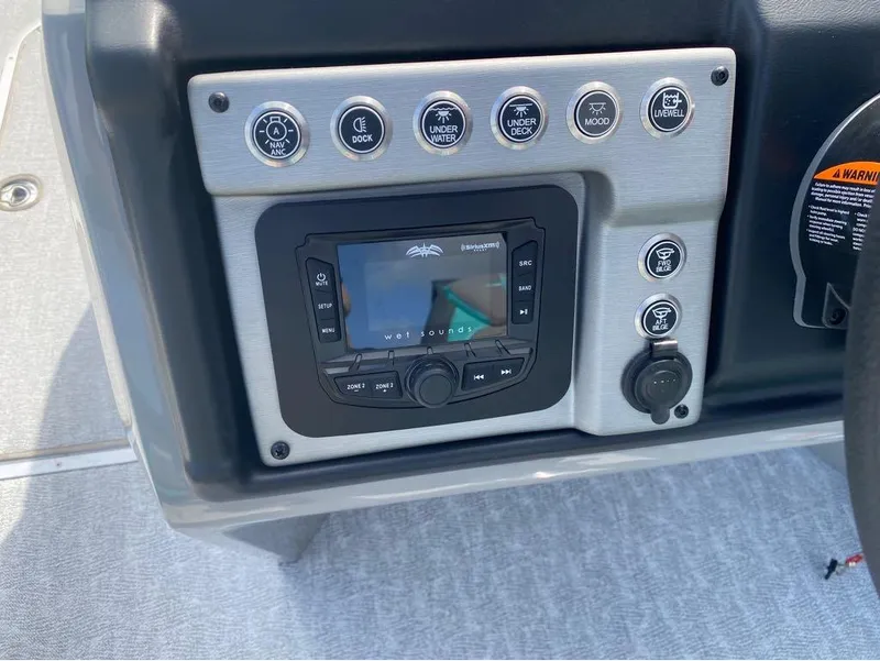 Slide: The Image of Control panel of 2025 Berkshire 25 SB2 STS boat with audio system and switches. - 16
