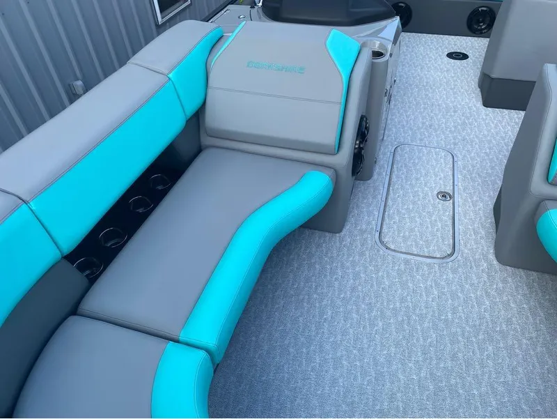 Slide: The Image of 2025 Berkshire 25 SB2 STS boat interior with gray and teal seating, carpeted floor. - 20
