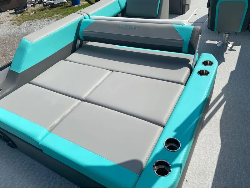 Slide: The Image of 2025 Berkshire 25 SB2 STS boat interior with teal and gray seating, cup holders. - 21