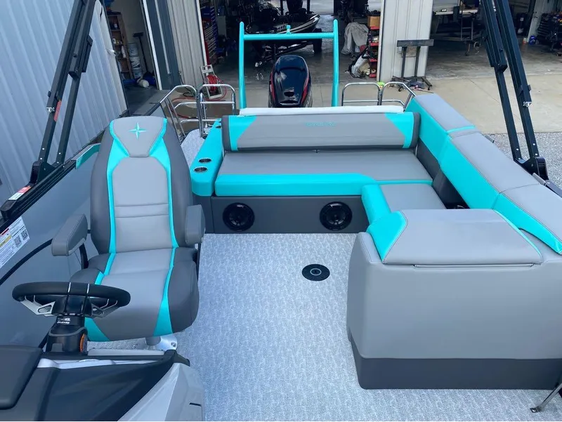 Slide: The Image of 2025 Berkshire 25 SB2 STS pontoon boat interior with gray and teal seating. - 3