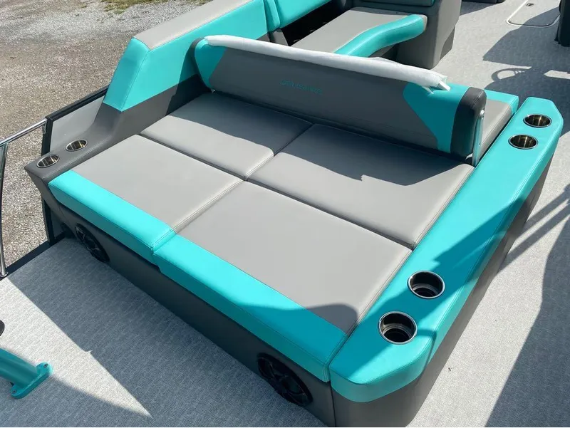 Slide: The Image of 2025 Berkshire 25 SB2 STS boat seating with teal and gray upholstery, featuring cup holders. - 9