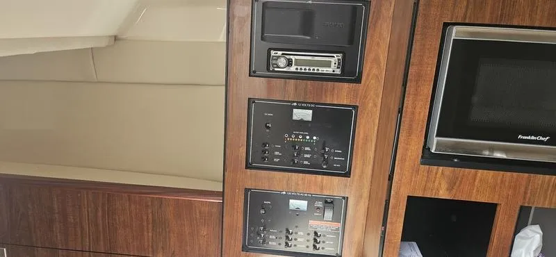 Slide: The Image of Interior of 2015 Monterey 295 Sport Yacht with control panels and microwave. - 10