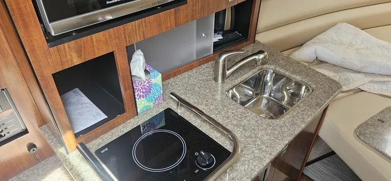 Slide: The Image of Interior of 2015 Monterey 295 Sport Yacht with kitchenette and sink. - 12