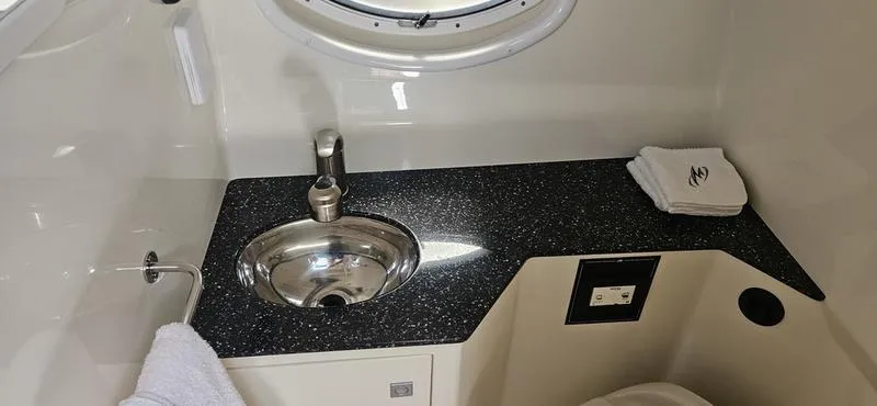 Slide: The Image of 2015 Monterey 295 Sport Yacht bathroom with sleek sink and countertop design. - 13